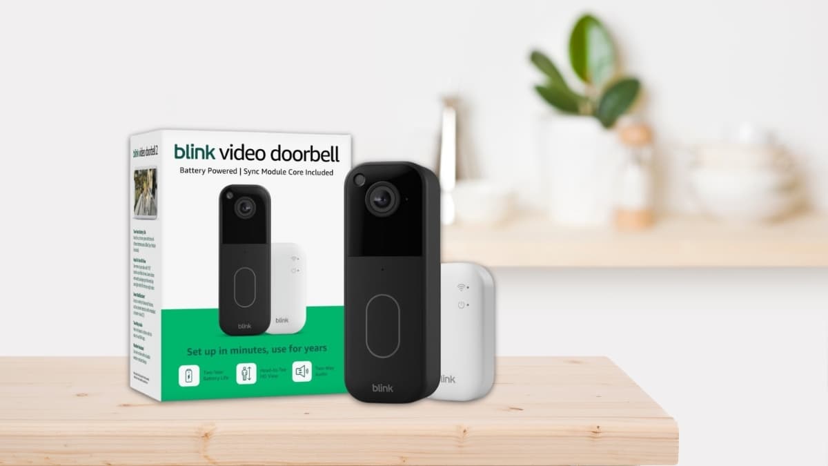 Blink Video Doorbell 2nd Gen with Sync Module Core shown on a wooden surface, featuring the battery-powered smart doorbell and retail packaging for home security.